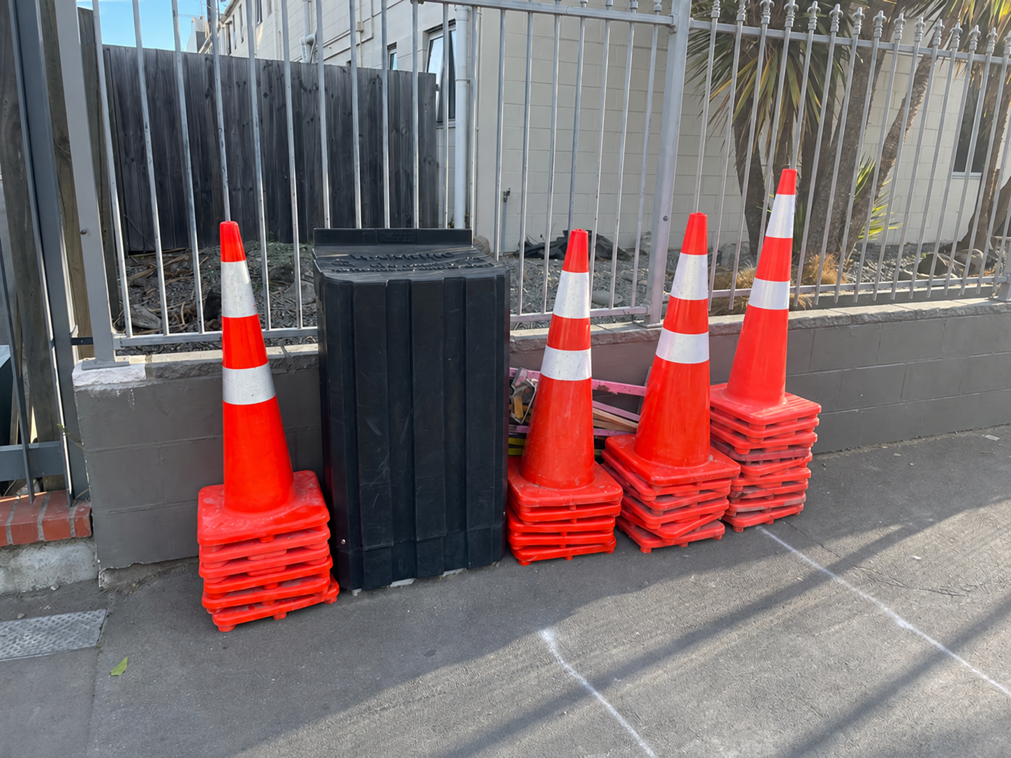 Unbranded New Zealand traffic cones and portable barriers prepared for field deployment